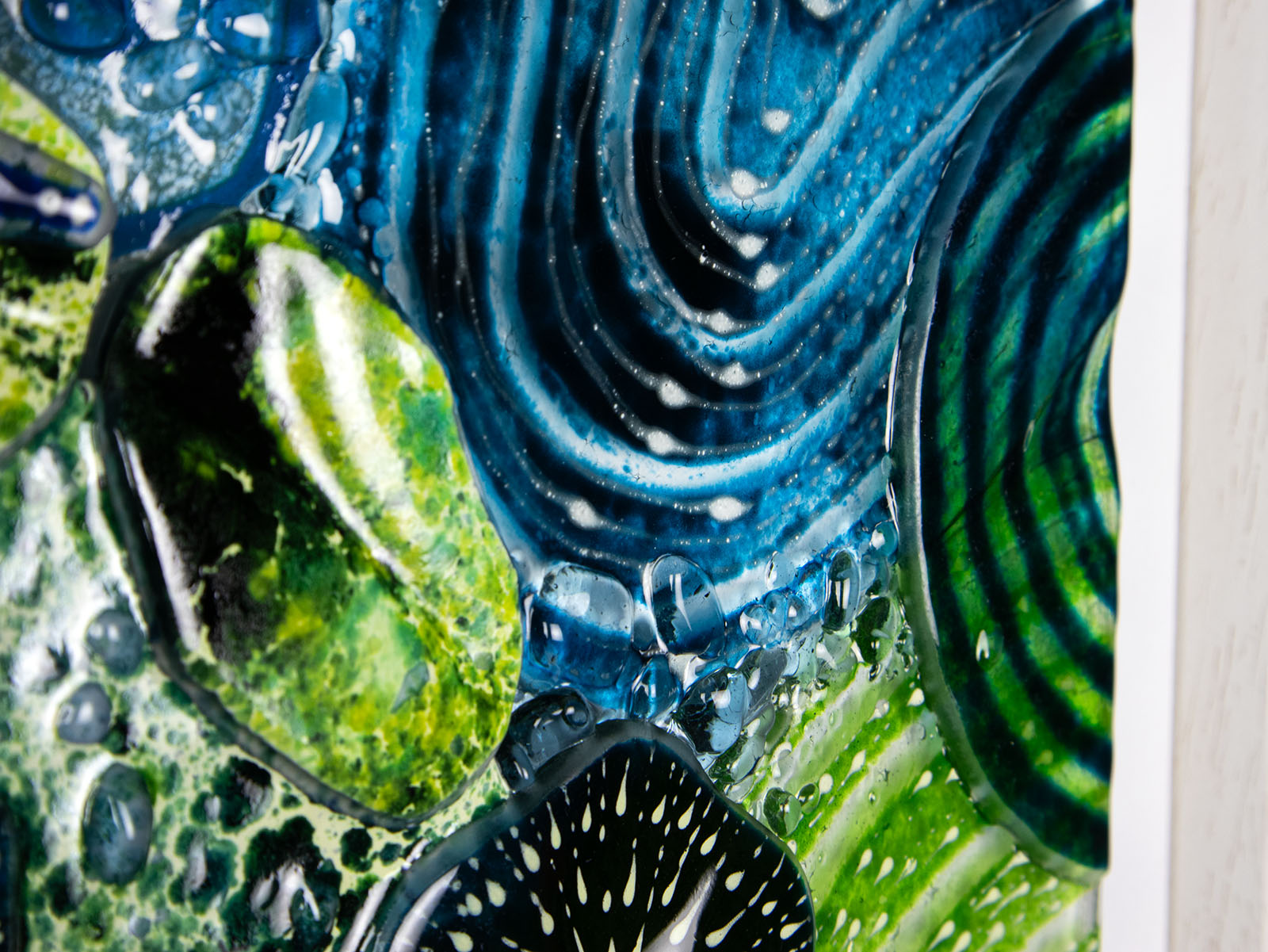 Close up of intricate ocean reef inspired fused glass art frame. Bright ocean blue colours and handmade wall art. 