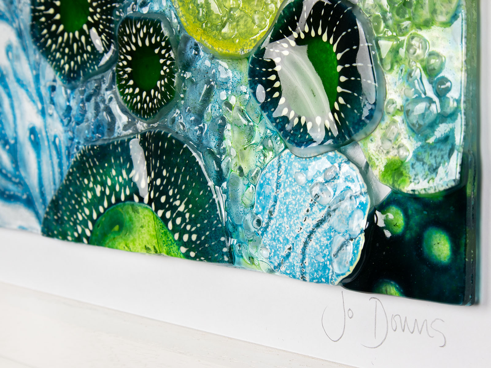 Close up of intricate ocean reef inspired fused glass art frame. Bright ocean blue colours and handmade wall art. 
