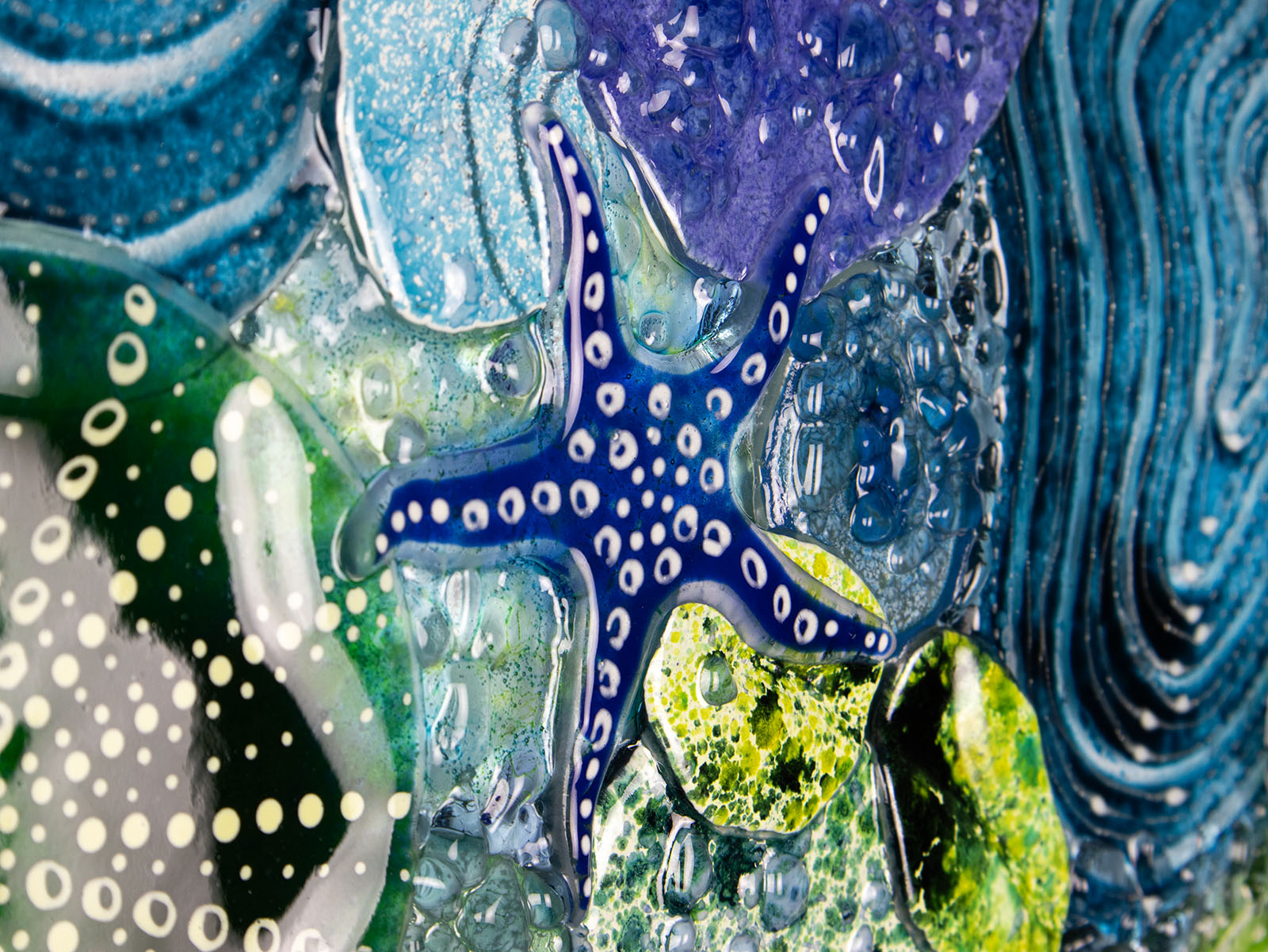 Close up of intricate ocean reef inspired fused glass art frame. Bright ocean blue colours and handmade wall art. 