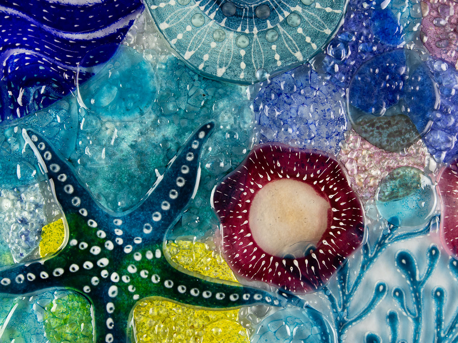 Close up of intricate ocean reef inspired fused glass art frame. A vibrant and handmade piece of wall art. 