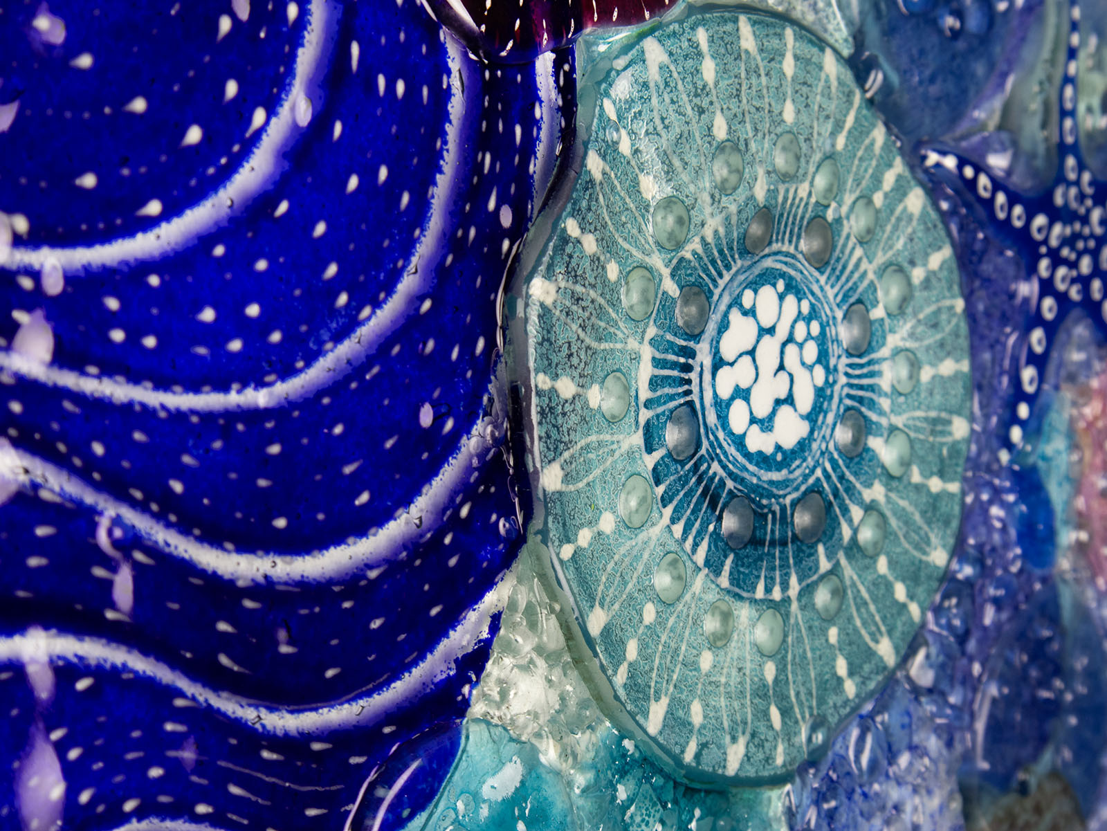 Close up of intricate ocean reef inspired fused glass art frame. A vibrant and handmade piece of wall art. 