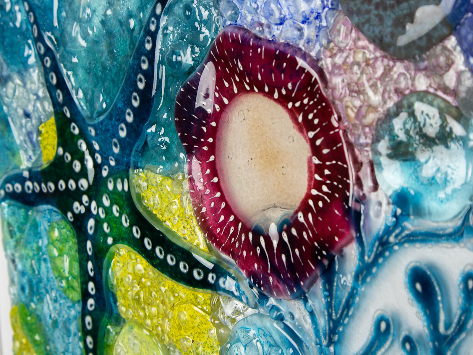 Close up of intricate ocean reef inspired fused glass art frame. A vibrant and handmade piece of wall art. 