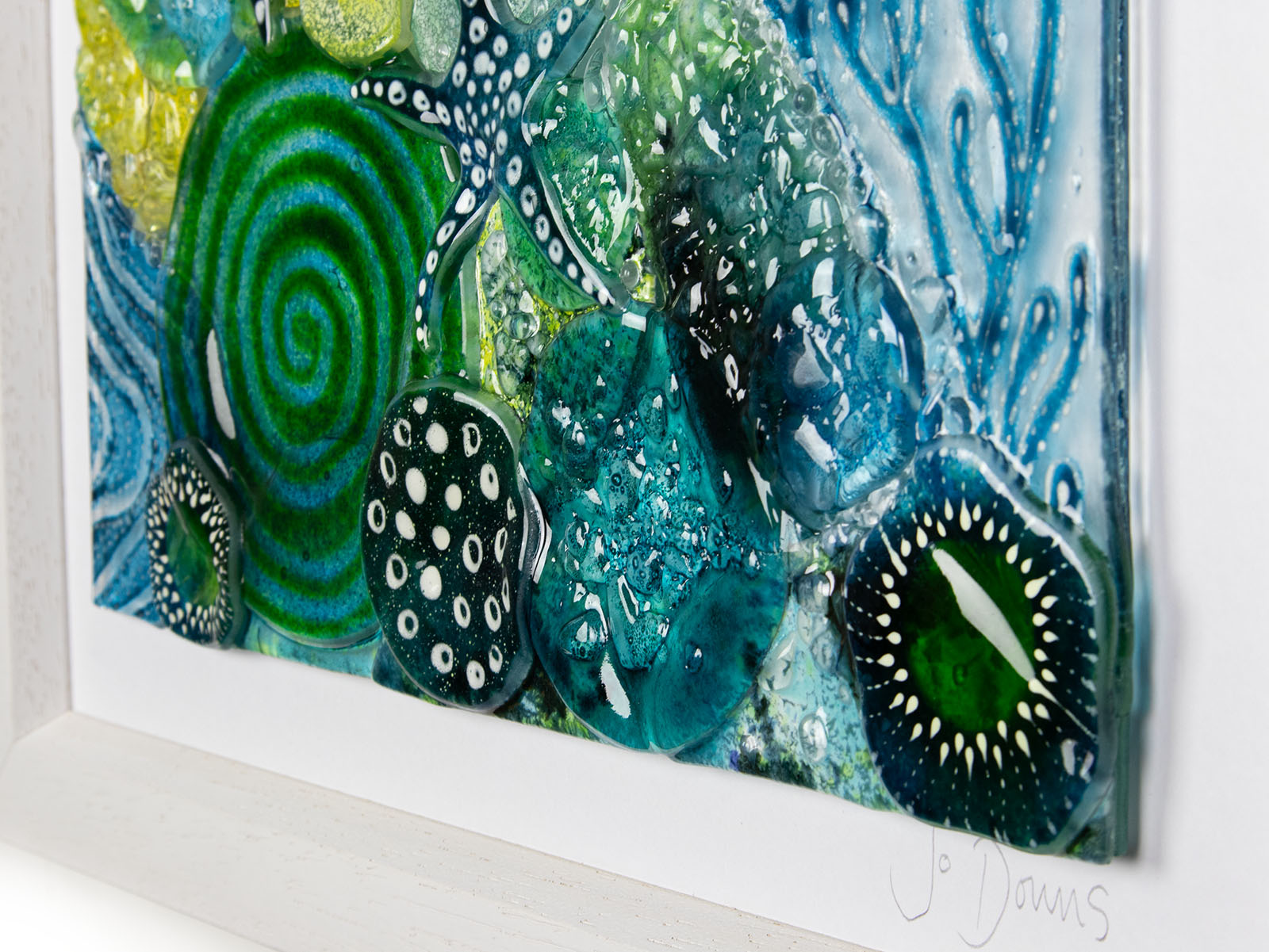 Close up of intricate ocean reef inspired fused glass art frame. A vibrant and handmade piece of wall art. 