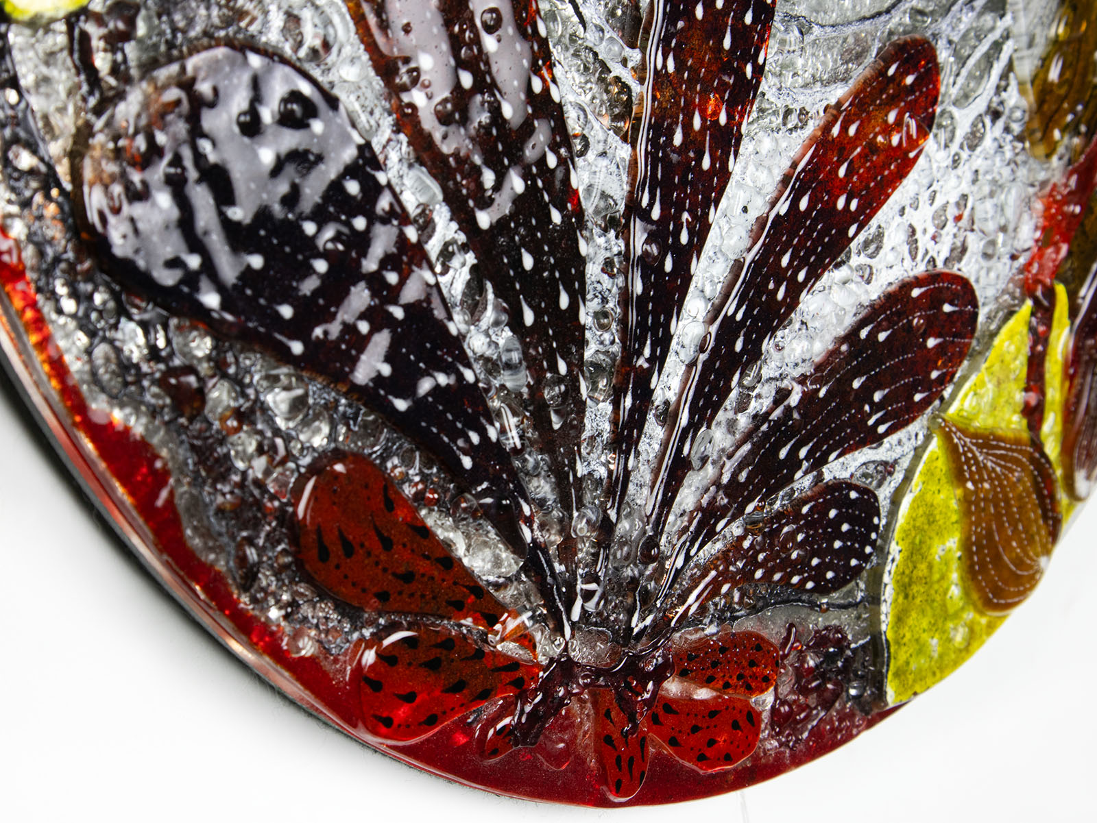 Details of fused glass round wall panel, made from fused glass, inspired by the autumnal country-side. Striking, handmade wall art with organic texture. 