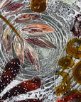 Close up of fused glass round wall panel, made from fused glass, inspired by the autumnal country-side. Striking, handmade wall art with organic texture. 