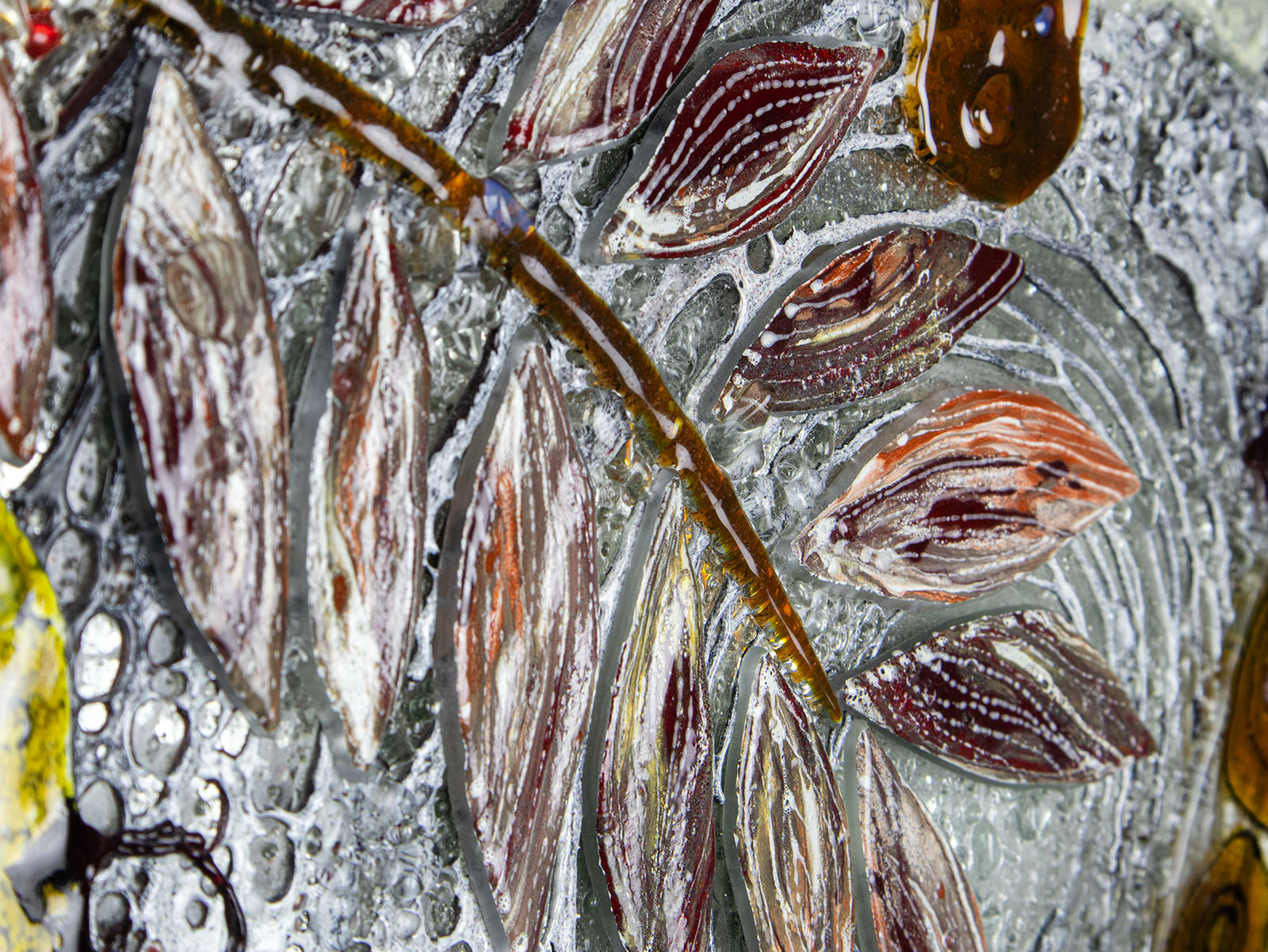 Leaf detailing of fused glass round wall panel, made from fused glass, inspired by the autumnal country-side. Striking, handmade wall art with organic texture. 