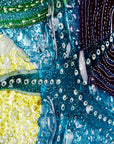 Stunning close up of round wall panel made from fused glass, inspired by the ocean reefs with starfish detailing and coastal colours. 