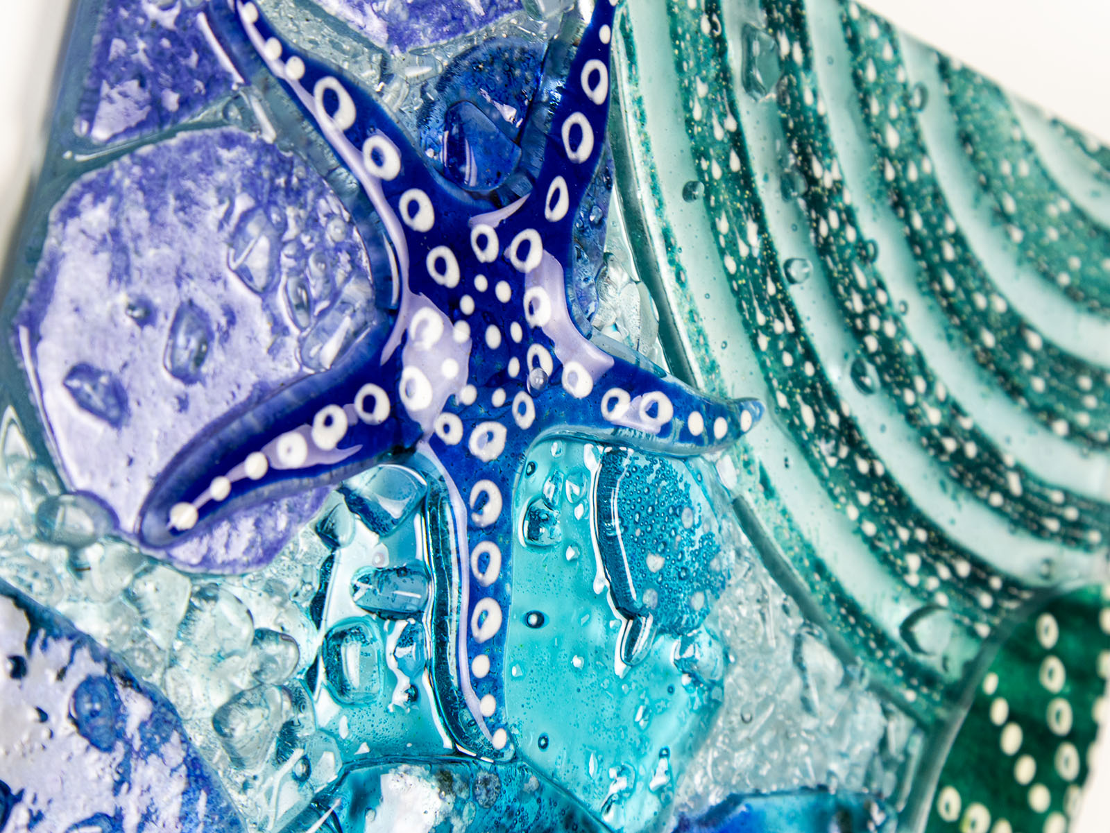 Detailed shot of fused glass art frame, inspired by the ocean with bright coastal colours. Beautiful wall art, hand-made in Cornwall, Launceston. 