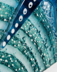 Highly detailed image of fused glass art frame inspired by the ocean, created with texture and coastal colours with pink hues. A unique piece of wall art, handmade in Cornwall, Launceston. 
