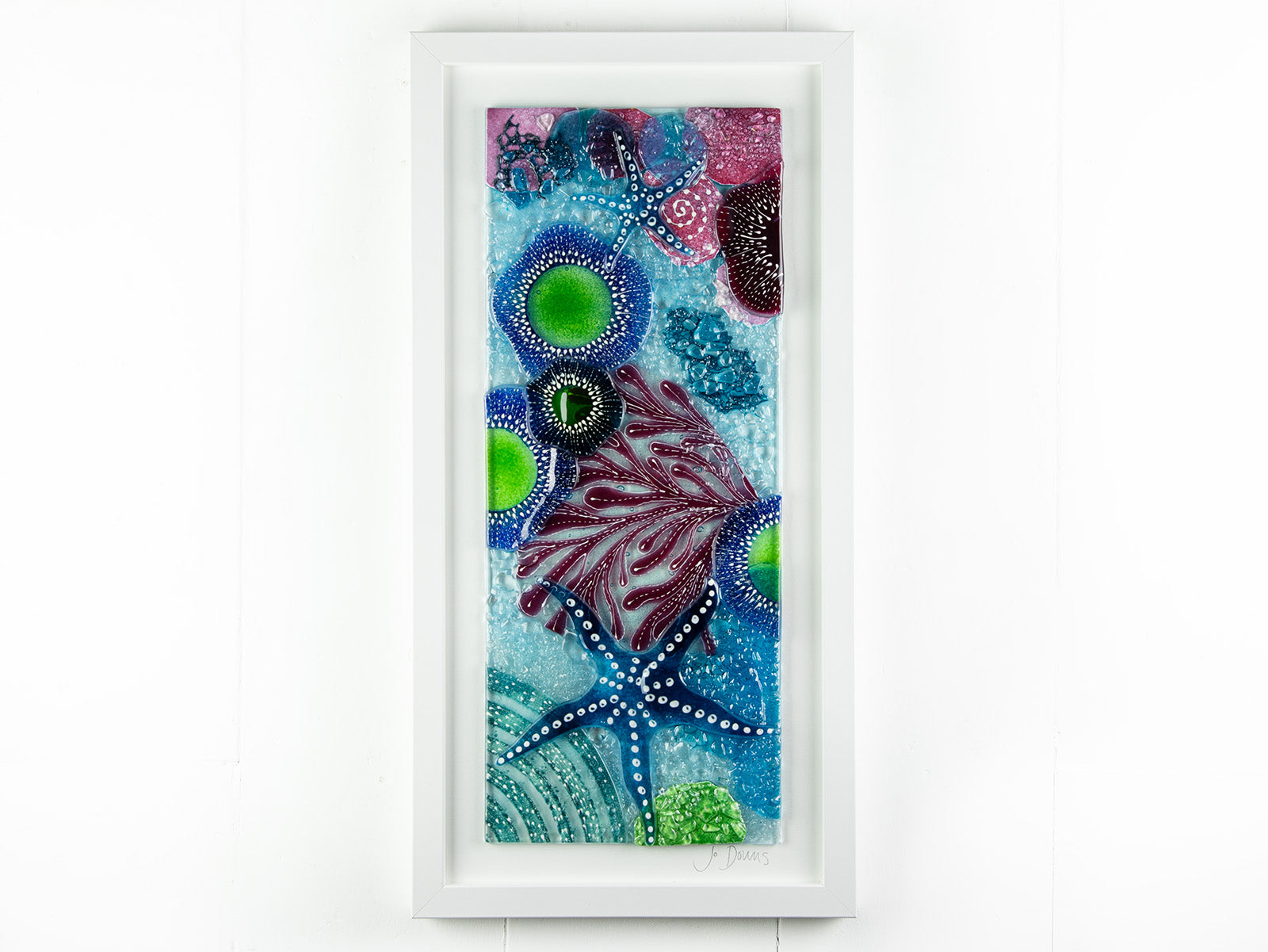 Fused glass art frame inspired by the ocean, created with texture and coastal colours with pink hues. A unique piece of wall art, handmade in Cornwall, Launceston. 