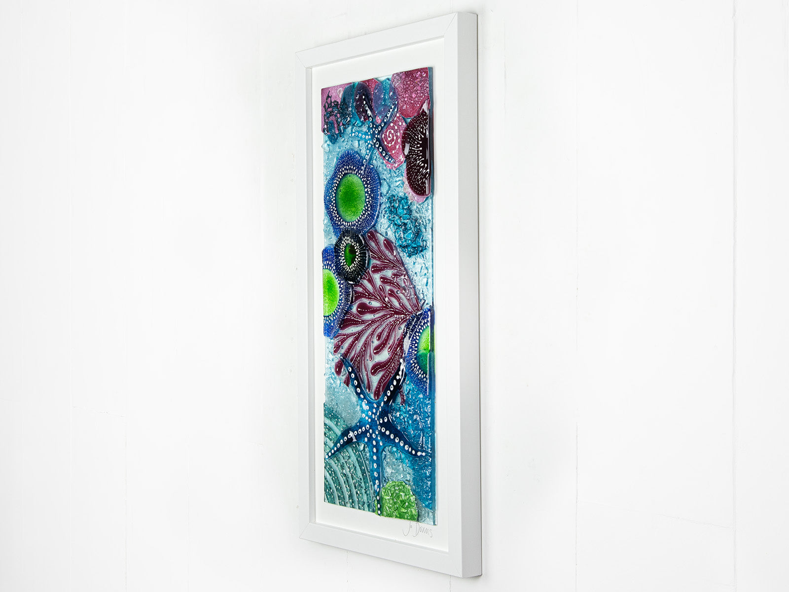 Fused glass art frame inspired by the ocean, created with texture and coastal colours with pink hues. A unique piece of wall art, handmade in Cornwall, Launceston. 