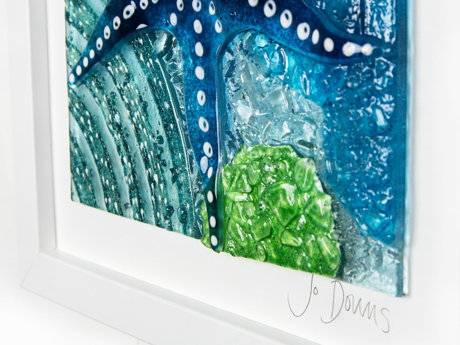 Signature shot on fused glass art frame inspired by the ocean, created with texture and coastal colours with pink hues. A unique piece of wall art, handmade in Cornwall, Launceston. 