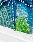 Signature shot on fused glass art frame inspired by the ocean, created with texture and coastal colours with pink hues. A unique piece of wall art, handmade in Cornwall, Launceston. 