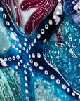 Close up of blue starfish in fused glass art frame inspired by the ocean, created with texture and coastal colours with pink hues. A unique piece of wall art, handmade in Cornwall, Launceston. 