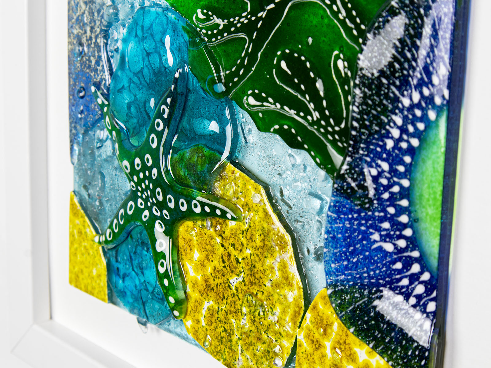 Close up of fused glass art frame, inspired by the ocean with bright coastal colours. Beautiful wall art, hand-made in Cornwall, Launceston. 