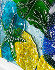 Close up of fused glass art frame, inspired by the ocean with bright coastal colours. Beautiful wall art, hand-made in Cornwall, Launceston. 
