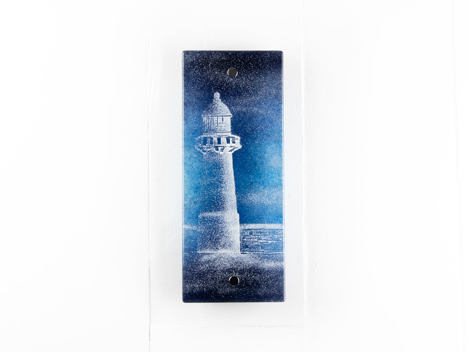 Fused glass wall panel with a lighthouse design in dark blues. Handmade wall art piece. 