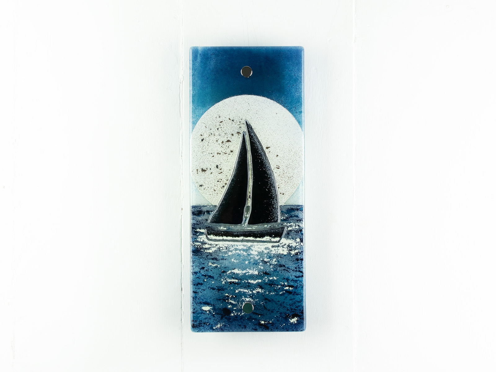 Fused glass small wall panel with deep teal colour-way and a full moon design, with a sail boat. 