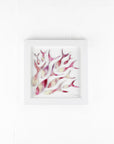 Art frame with hand-cut fused glass shoal of fish in a sunset pink colour-way, inspired by the ocean.