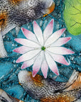 A close up of a fused glass round panel featuring hand-painted koi carp design with waterlilies and marine blue background. 