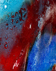 Bubbled close up shot of a striking 95cm fused glass hear shaped wall panel handcrafted in Cornish studio in bright reds, aqua blues and lots of textured detailing. 
