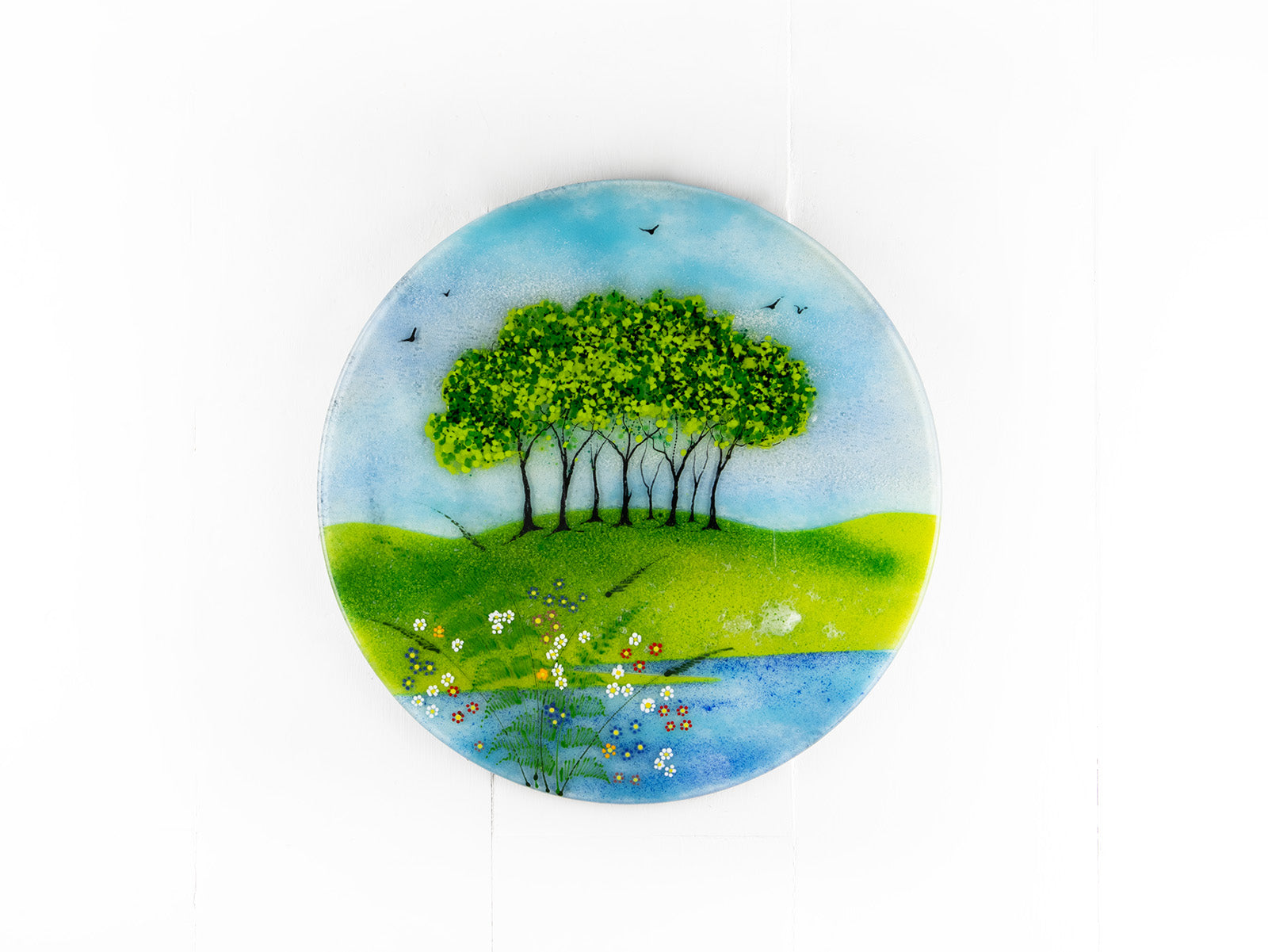 Fused glass round panel, inspired by the Nearly Home Trees in Devon, designed in bright summer greens. 