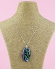 Fused glass pendant necklace, handmade in spring greens and pinks, with botanical hand-painted design.  Hung on a sterling silver chain. 