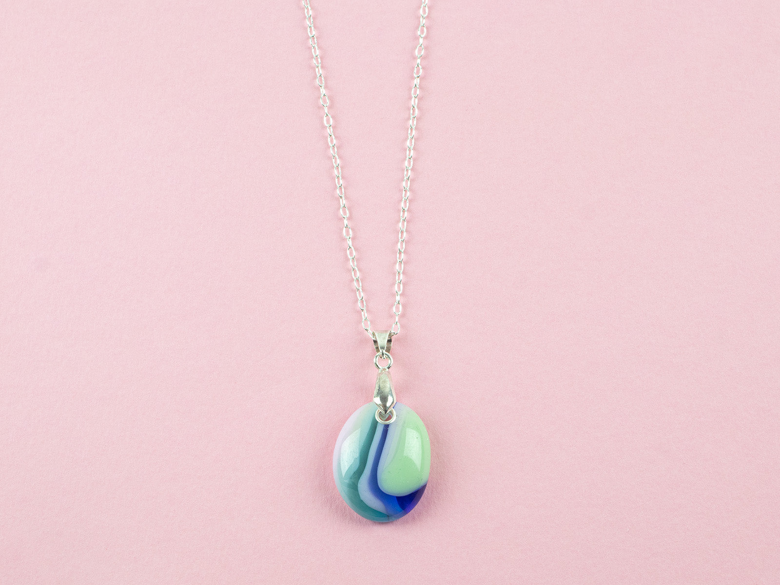 A fused glass pedant necklace, hung o a sterling silver chain, handmade in pastel, spring colours. 