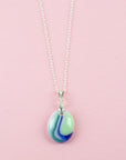 A fused glass pedant necklace, hung o a sterling silver chain, handmade in pastel, spring colours. 