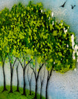 Painted detail of the tree's on a fused glass round panel, inspired by the Nearly Home Trees in Devon, designed in bright summer greens. 