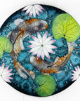 A fused glass round panel featuring hand-painted koi carp design with waterlilies and marine blue background. 