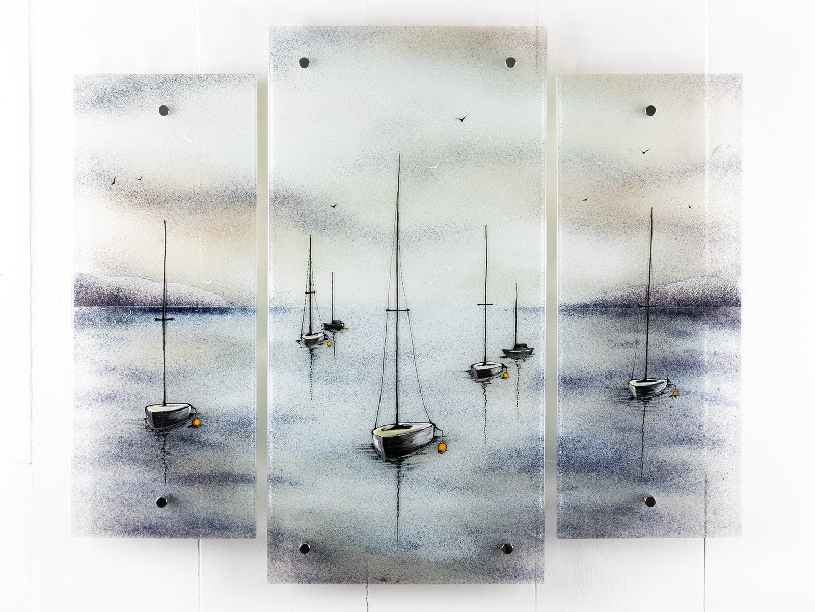 Fused glass staggered triptych featuring a hand-painted sailboat design in a soft and misty colour-way. 