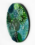 Fused glass round panel, handmade using ocean colours and botanical and organic painted designs. An abstract, coastal inspired piece of wall art. 
