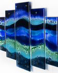 A side image of a fused glass quintych featuring an ocean blue colour-way, inspired by the coast.