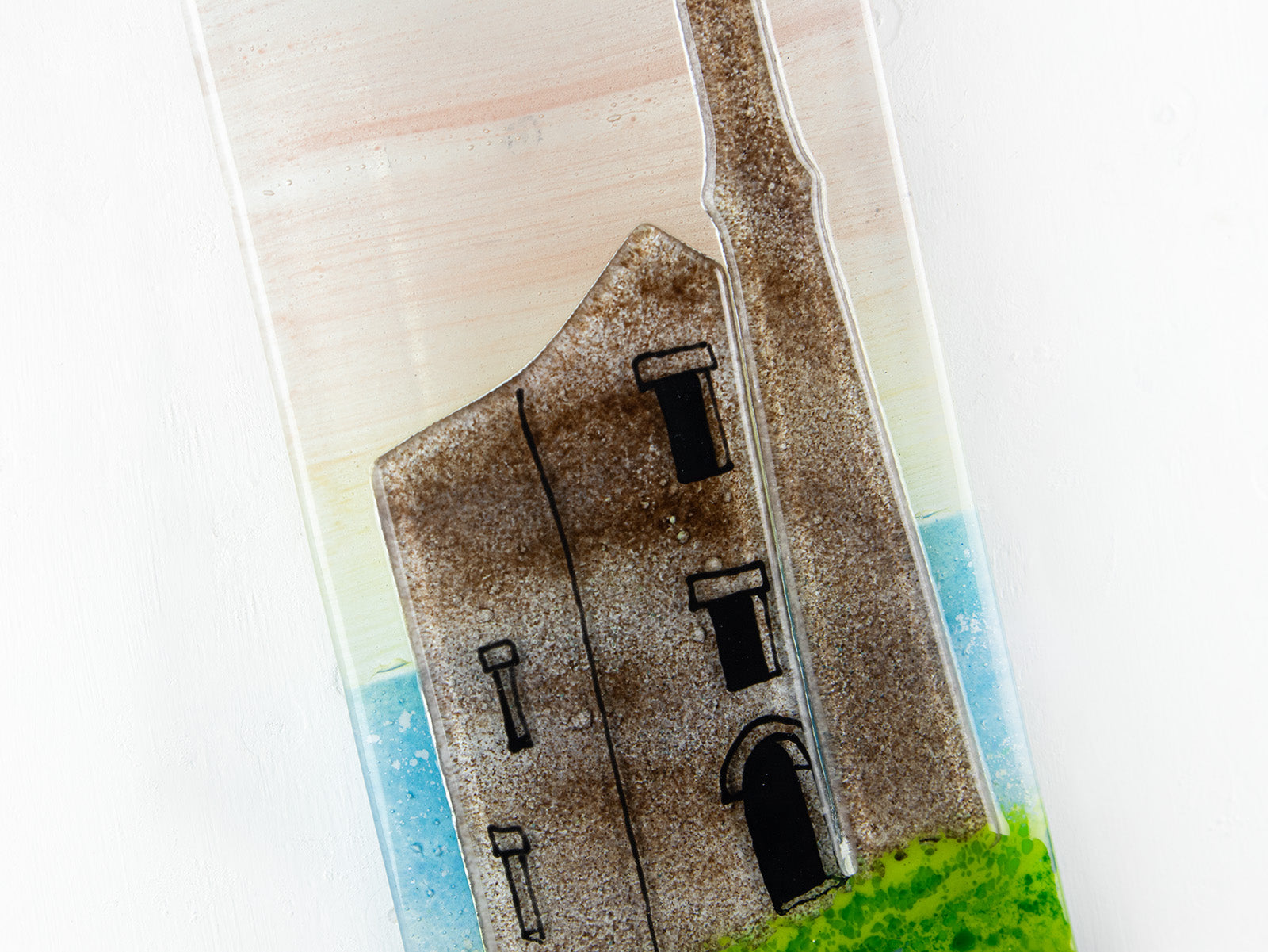 Close up of a Cornish tin mine on a fused glass extra small wall panel, featuring soft sunset sky, coastal landscape.