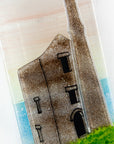 Close up of a Cornish tin mine on a fused glass extra small wall panel, featuring soft sunset sky, coastal landscape.