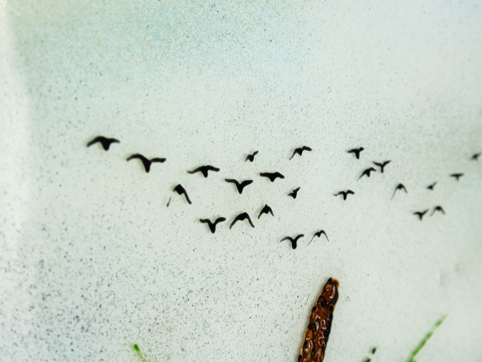 Close up of coastal soaring birds, hand-painted on a fused glass design with soft ocean colours. 